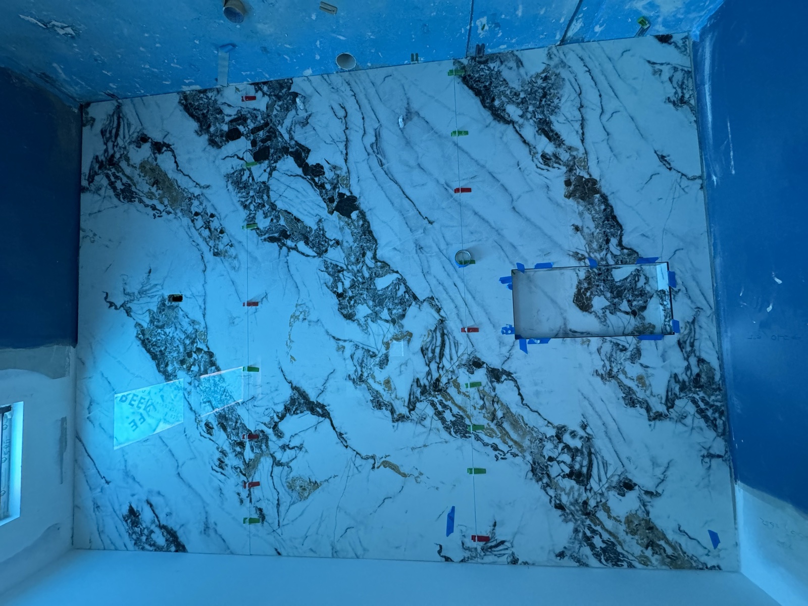 Dramatic marble feature wall installation in progress, Rong Xiang Tilers